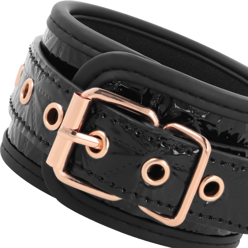 Detalle de las tobilleras Begme Black Edition negras con hebilla en tono oro rosa.