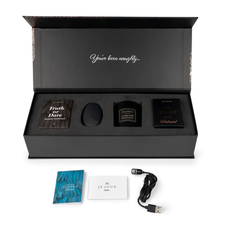 Je Joue The Naughty Gift Set en caja negra abierta con varios accesorios visibles