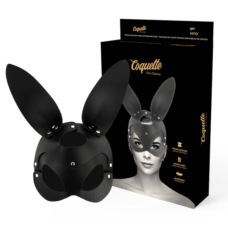 Antifaz Coquette Chic Desire negro con orejas de conejo, con la caja del producto detrás.