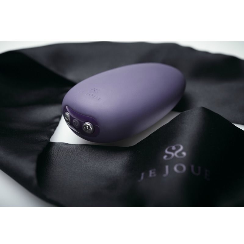 Je Joue Mimi Soft morado en detalle, con tres botones visibles sobre una funda negra.