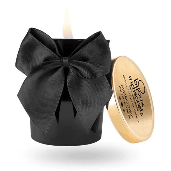 Vela de masaje Bijoux Melt My Heart negra con gran lazo y tapa apoyada al lado.