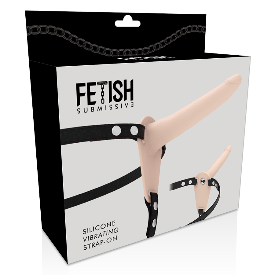 Caja del producto Fetish Submissive Harness con strap-on tono piel ilustrado en el frontal.
